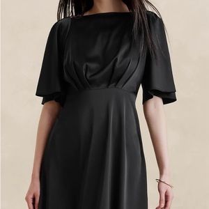 Beautiful “silk like” fabric, flutter sleeved dress.